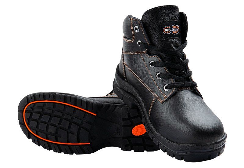 A pair of black and orange safety boots on a white background