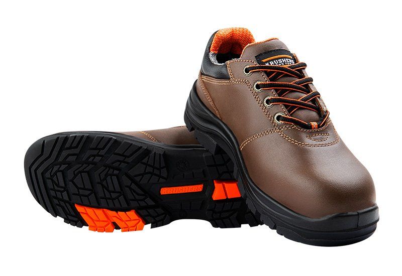 A pair of brown and black safety shoes on a white background