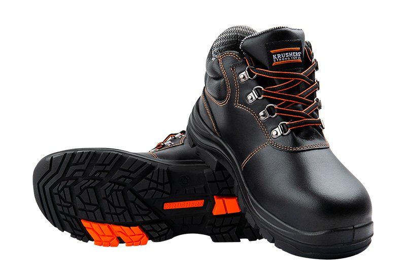 A pair of black and orange safety boots on a white background