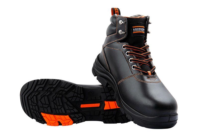 A pair of black and orange safety boots on a white background