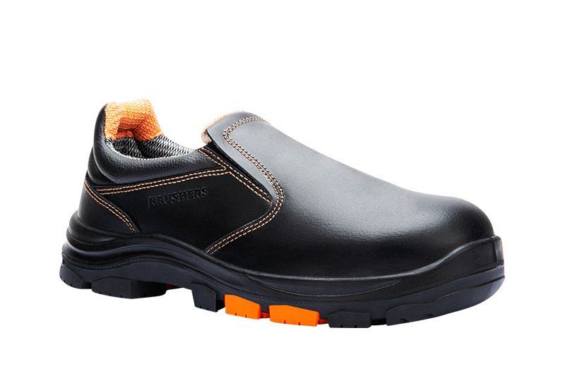 A pair of black and orange safety shoes on a white background.