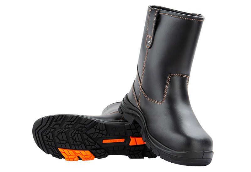 A pair of black boots with orange soles on a white background.