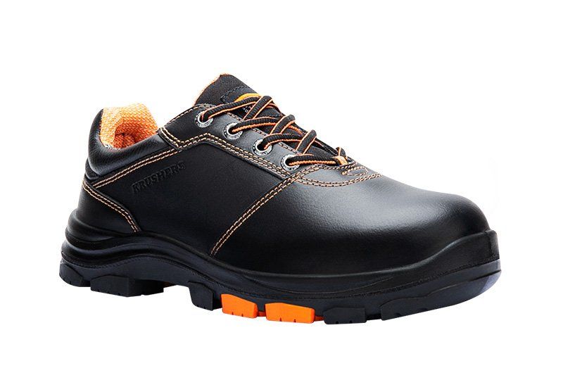 A pair of black and orange safety shoes on a white background.