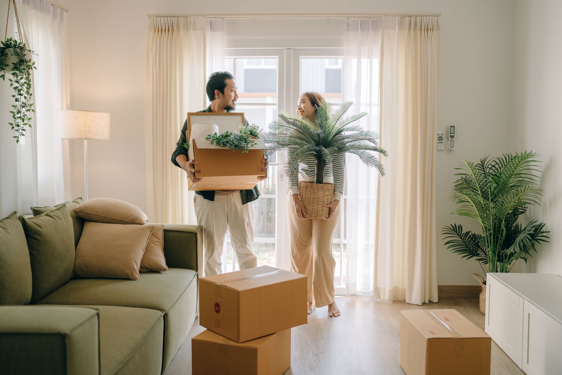 Couple unpacking boxes in their new home after a smooth move with a professional Moving Company in Cranberry Township Pa.
