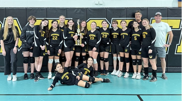 Catholic Youth Sports volleyball team with a trophy
