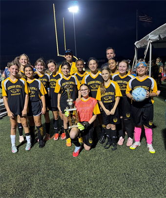 Catholic Youth Sports soccer team with a trophy