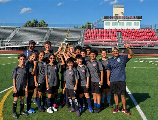 Catholic Youth Sports track team holding a trophy