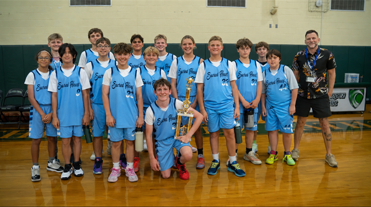 Catholic Youth Sports basketball team holding a trophy