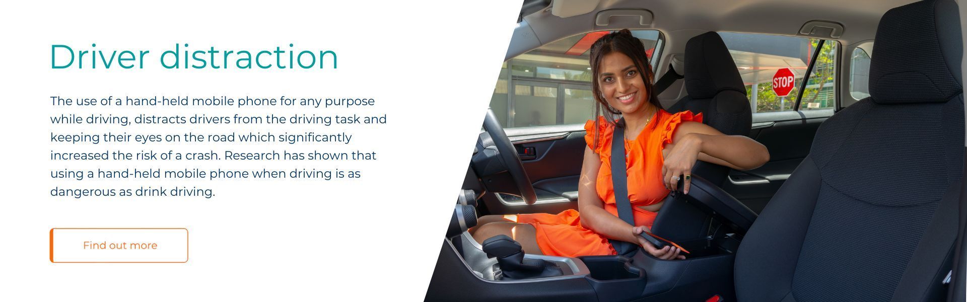 A woman is sitting in the driver 's seat of a car.