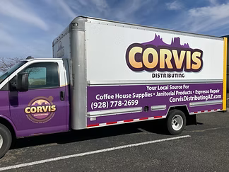 Corvis delivery truck with purple and white branding parked outdoors