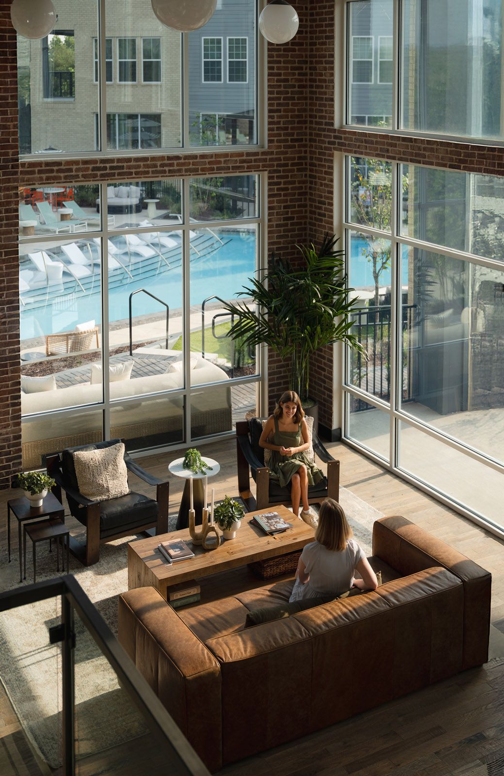 A bedroom with a bed , two nightstands , two windows and a ceiling fan.