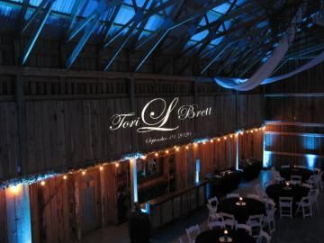 Lit rustic venue with glowing string lights and a “Font & Brew” sign under a blue-lit ceiling