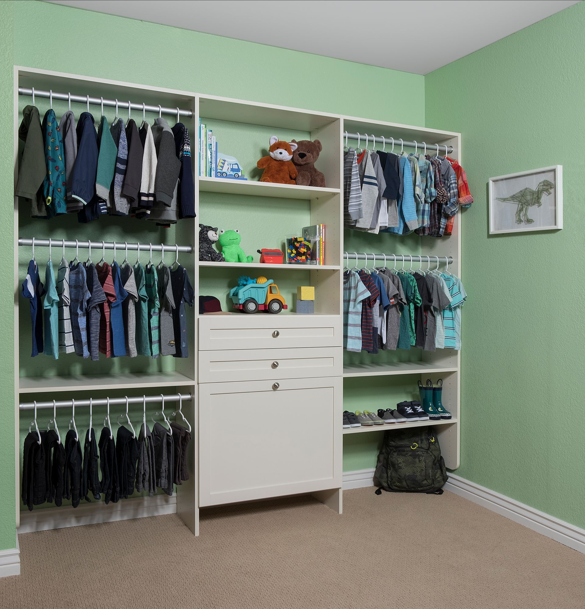 Walk-in closet with light blue cabinets, filled with clothes, shoes, and accessories.