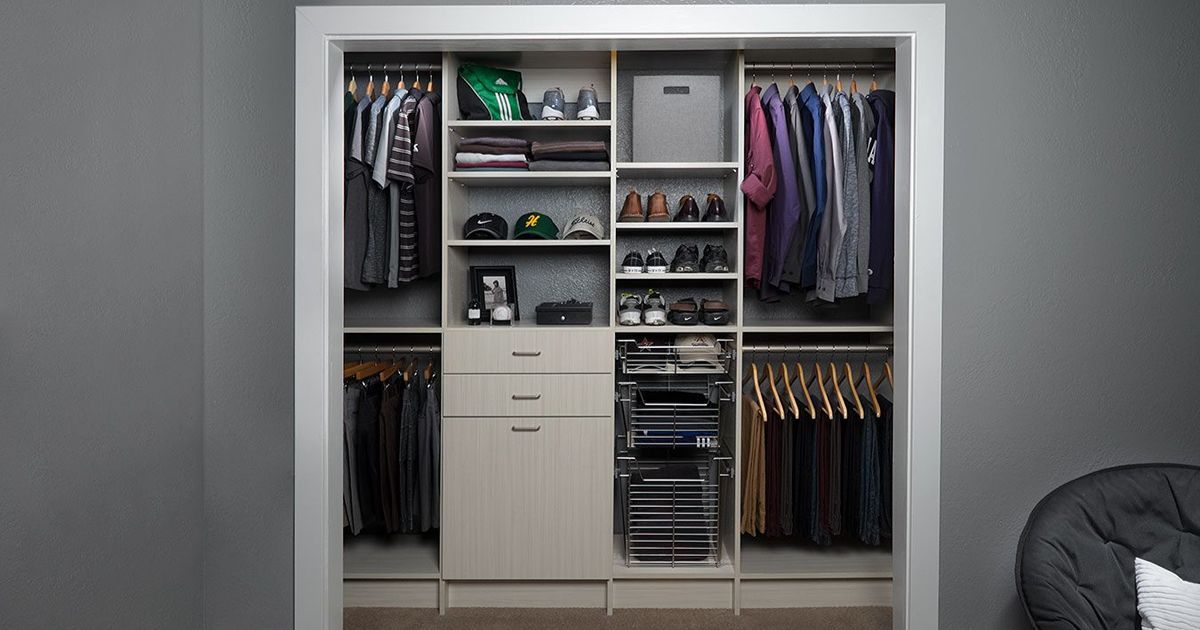 Organized closet with hanging clothes, shelves for shoes, and drawers, with a neutral color scheme.