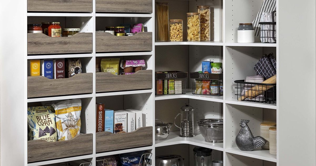 White pantry with wooden pull-out drawers, shelves filled with food items, and a corner storage area.