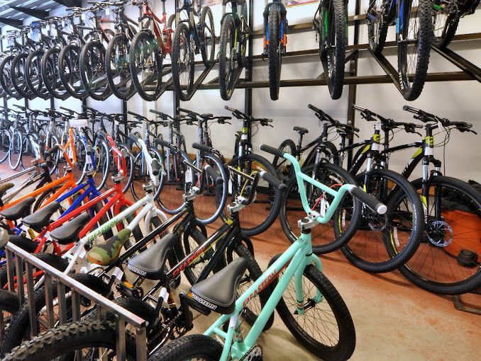 A bunch of bikes are lined up in a room