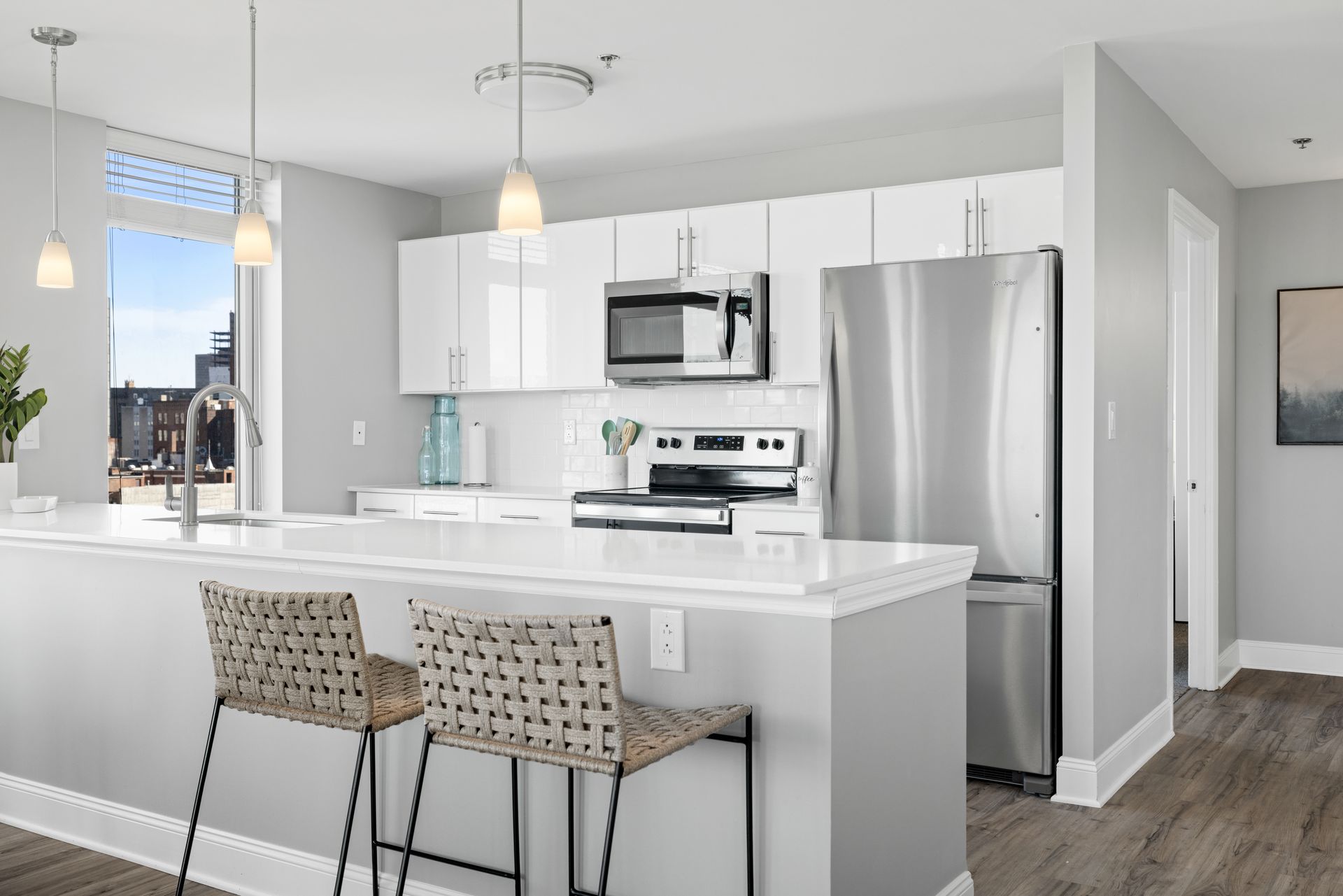 A kitchen with stainless steel appliances and white cabinets