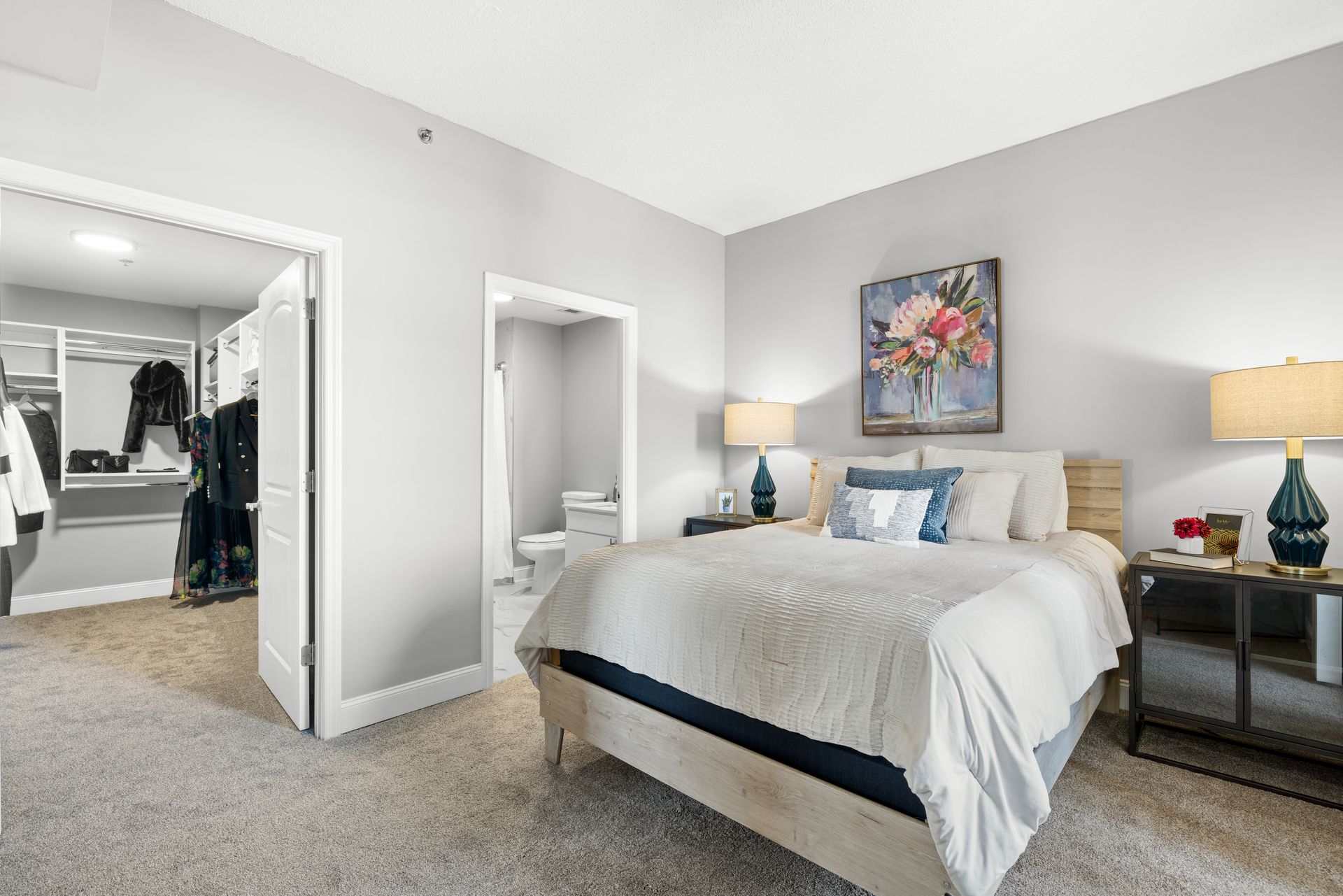 A bedroom with a large bed and a walk in closet.