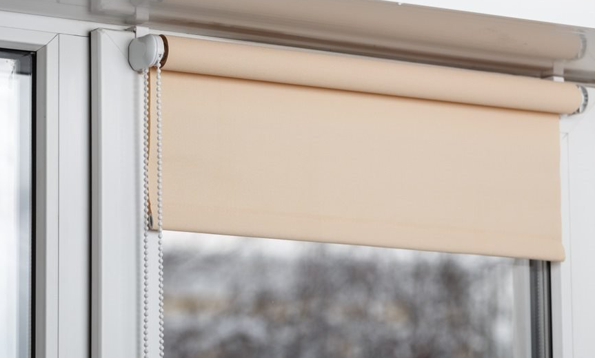 peach roller blind over glass door