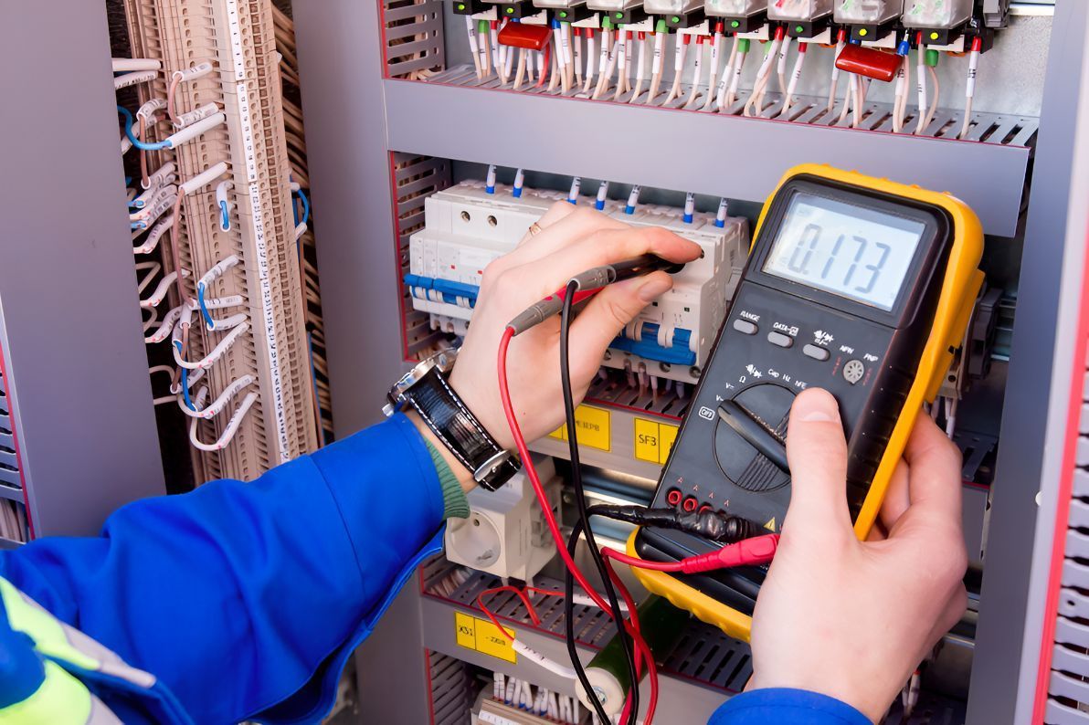 An Electrician Is Using A Multimeter To Test A Circuit Board — Entire Power Solutions In Cameron Park, NSW
