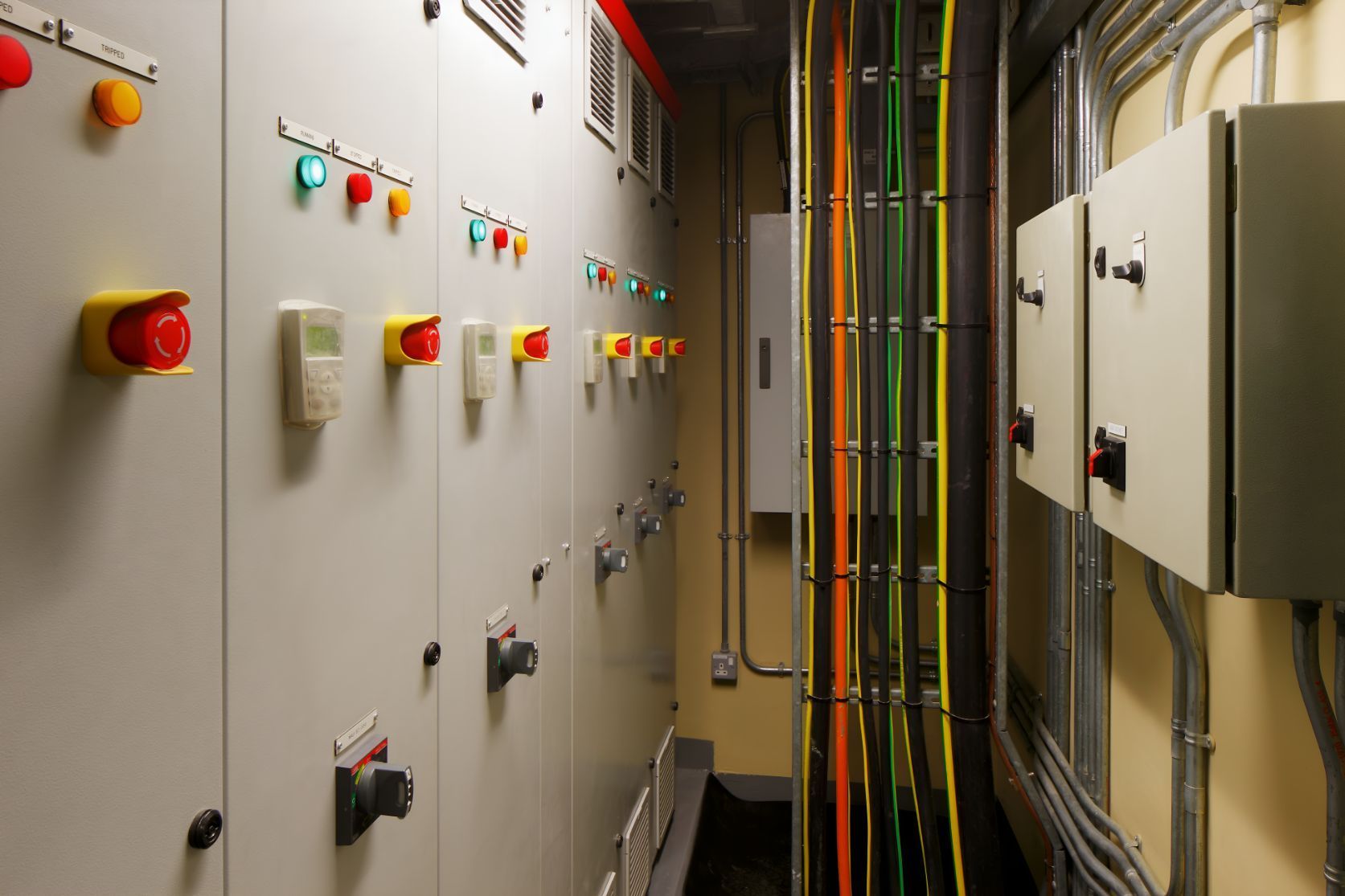 A Hallway Filled With Electrical Boxes And Wires — Entire Power Solutions In Rutherford, NSW