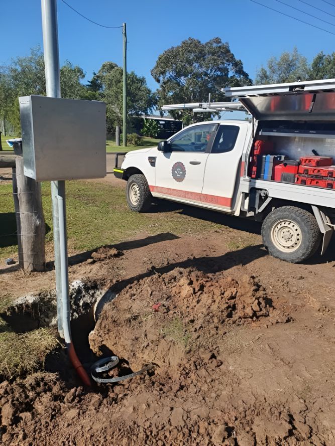 A White Truck Is Parked In The Dirt Next To A Box — Entire Power Solutions In Branxton, NSW