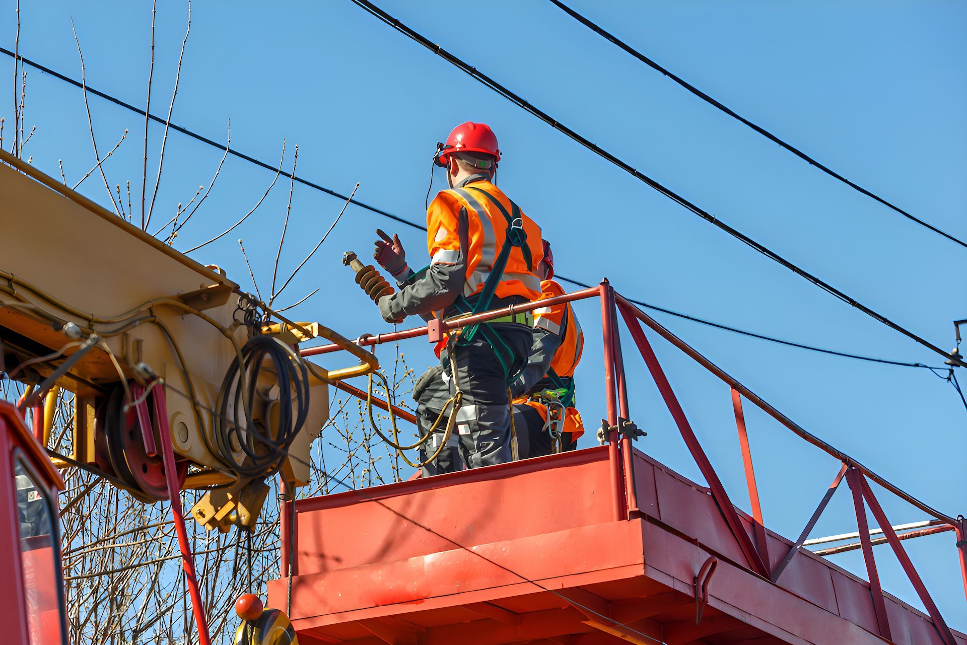 A Man Is Working On An Electrical Box On A Crane — Entire Power Solutions In Ashtonfield, NSW