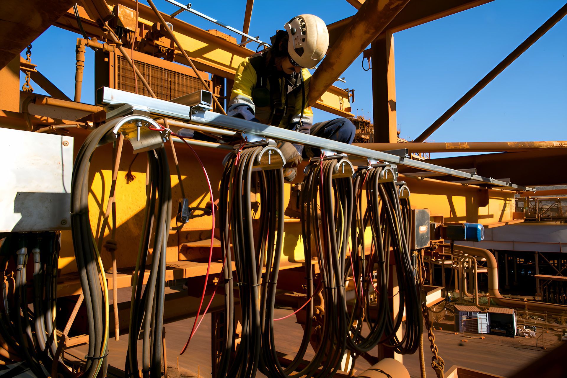 A Man Is Working On A Yellow Machine— Entire Power Solutions In Mayfield, NSW