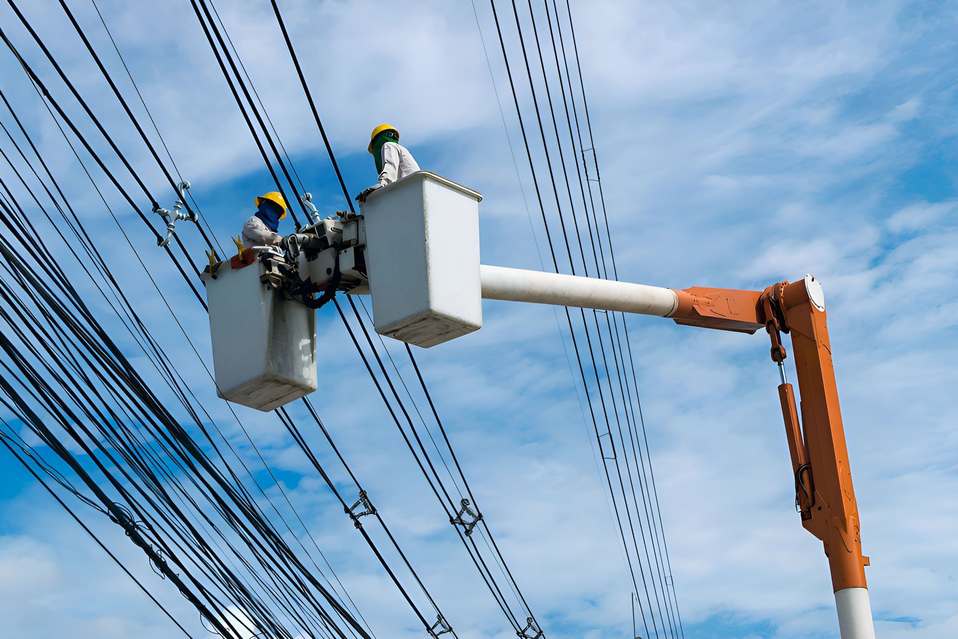Two Men Are In A Crane Working On Power Lines — Entire Power Solutions In Maitland, NSW