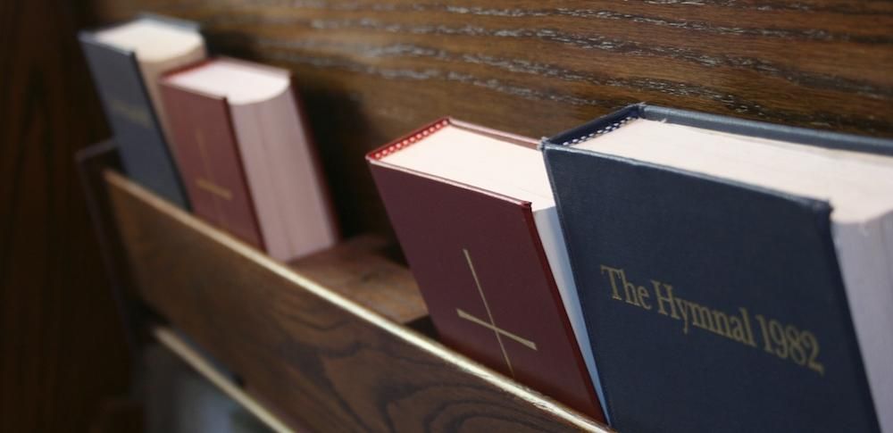 A row of books including the hymnal 1992