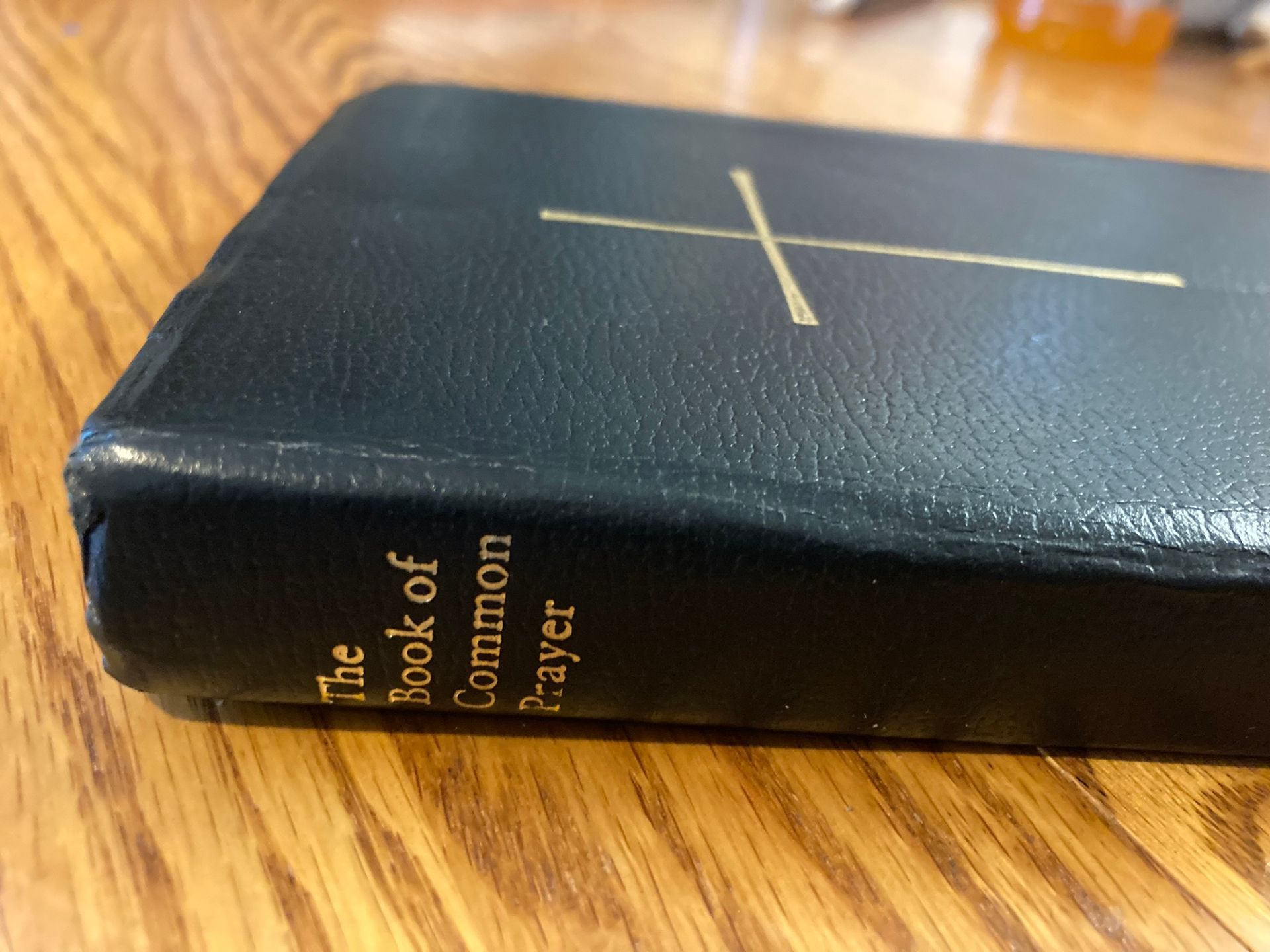 The book of common prayer is on a wooden table