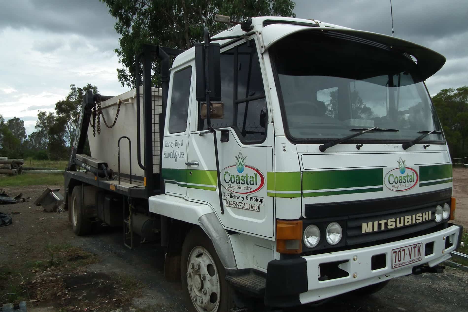 White Coastal Truck with Green Stripes — Coastal Skip Bin Hire In Craignish, QLD