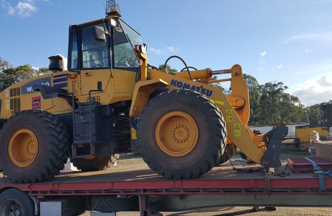 Yellow Komatsu Wheel Loader on A Flatbed Trailer, Ready for Transport — Coastal Skip Bin Hire In Craignish, QLD