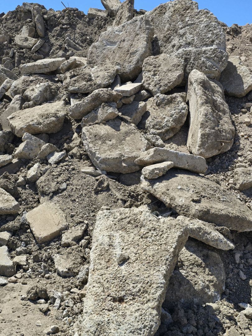 Pile of Broken Concrete Rubble and Debris on the Ground in Bright Sunlight — Coastal Skip Bin Hire In Craignish, QLD