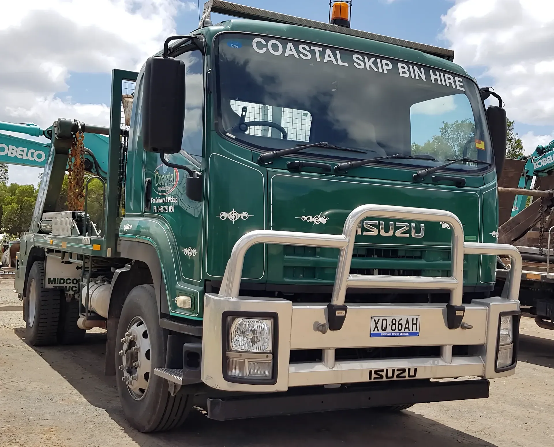 Green Isuzu skip bin truck with 