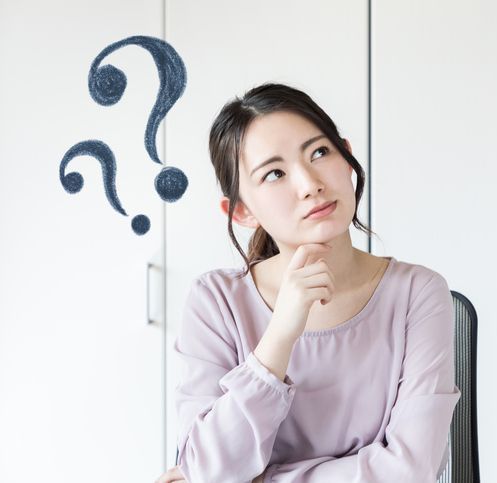 A woman is sitting in a chair with a question mark above her head.