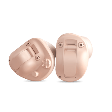 Two beige hearing aids, positioned on a white surface, showcasing the battery compartments.
