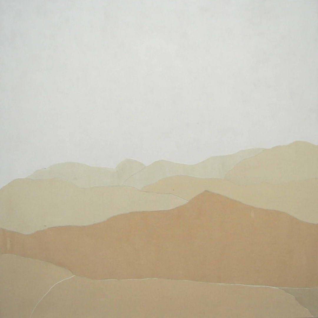 It is a painting of a desert landscape with mountains in the background.