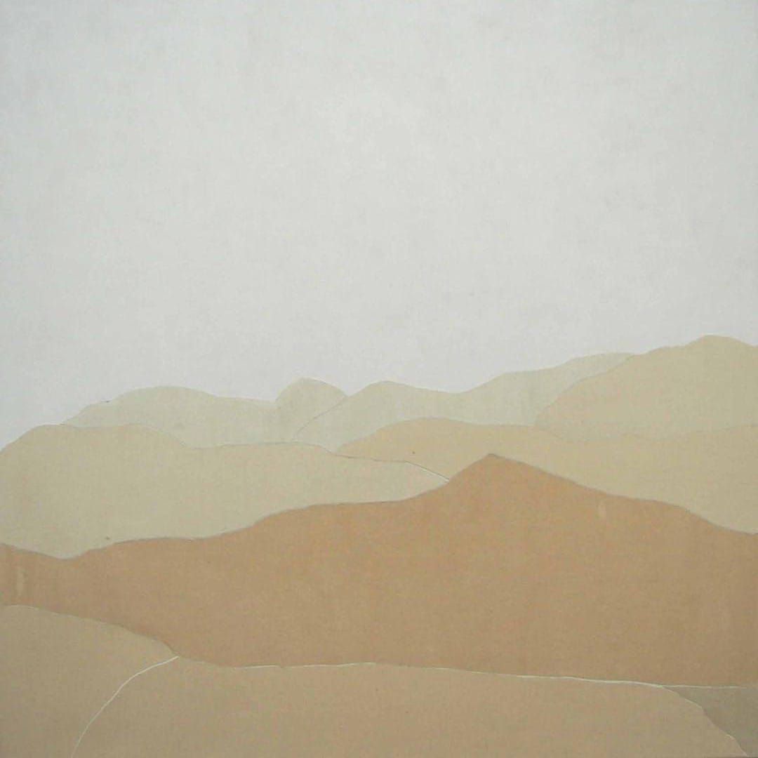 It is a painting of a desert landscape with mountains in the background.