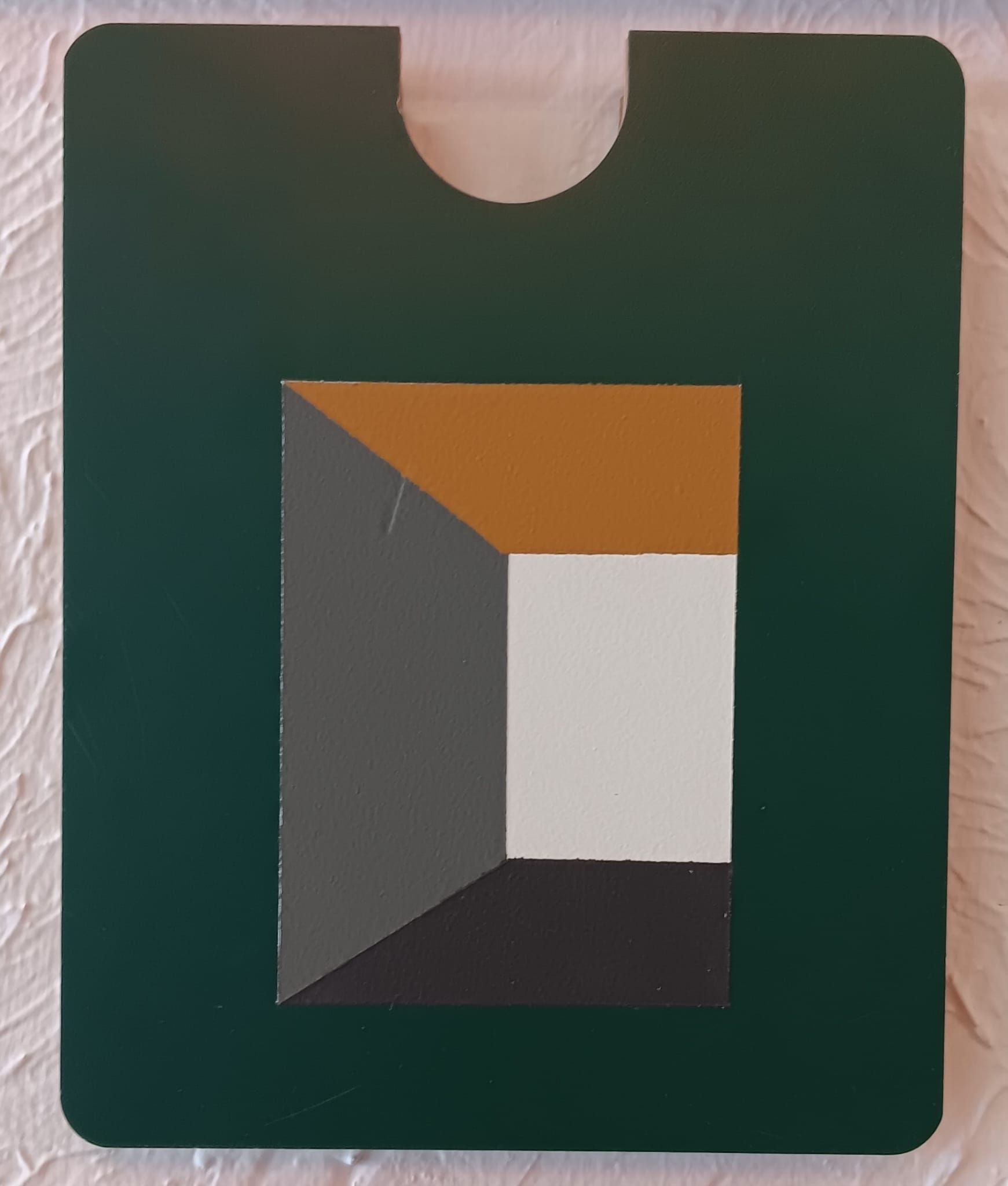 A green card holder with a geometric design on it