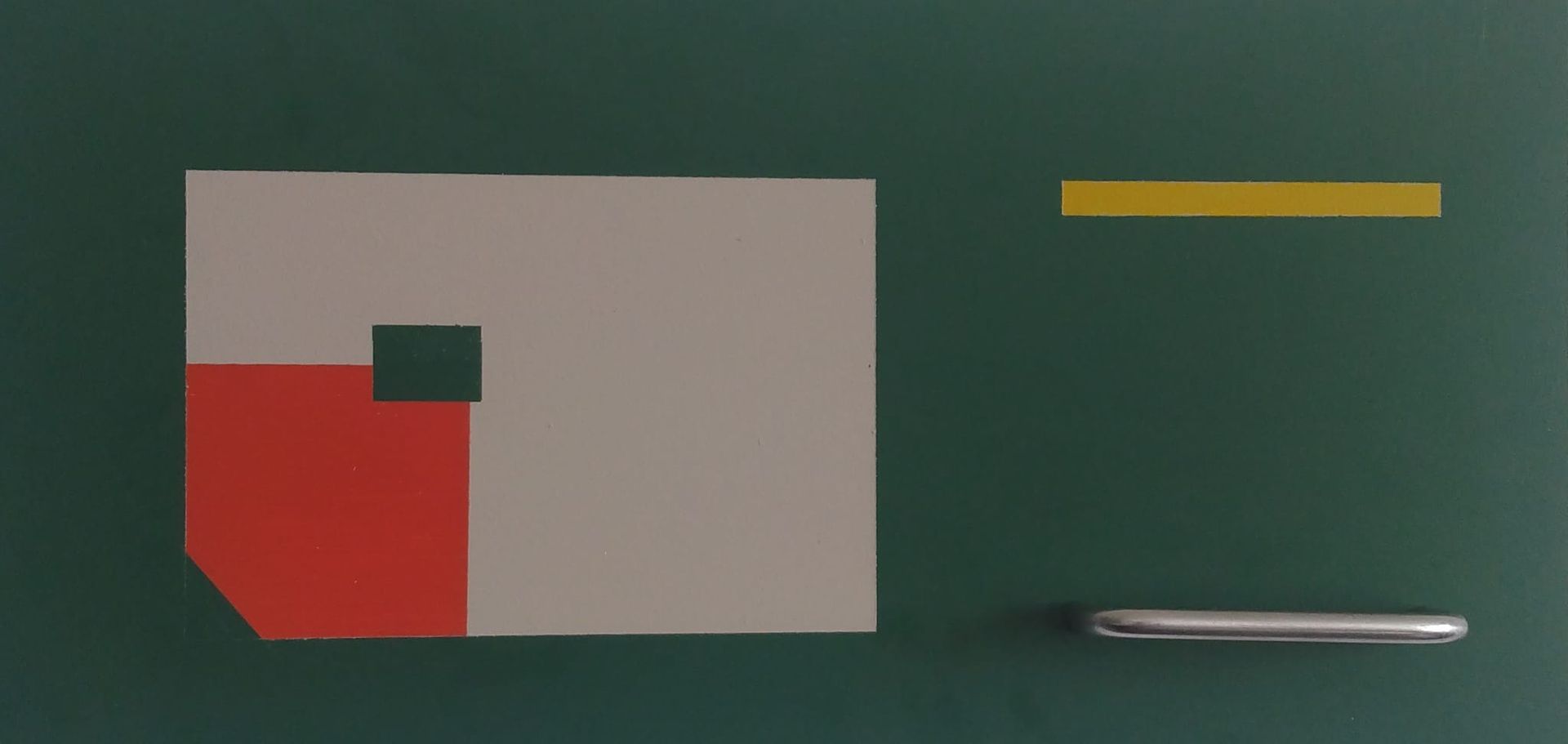 A green board with a piece of paper and a pen on it.