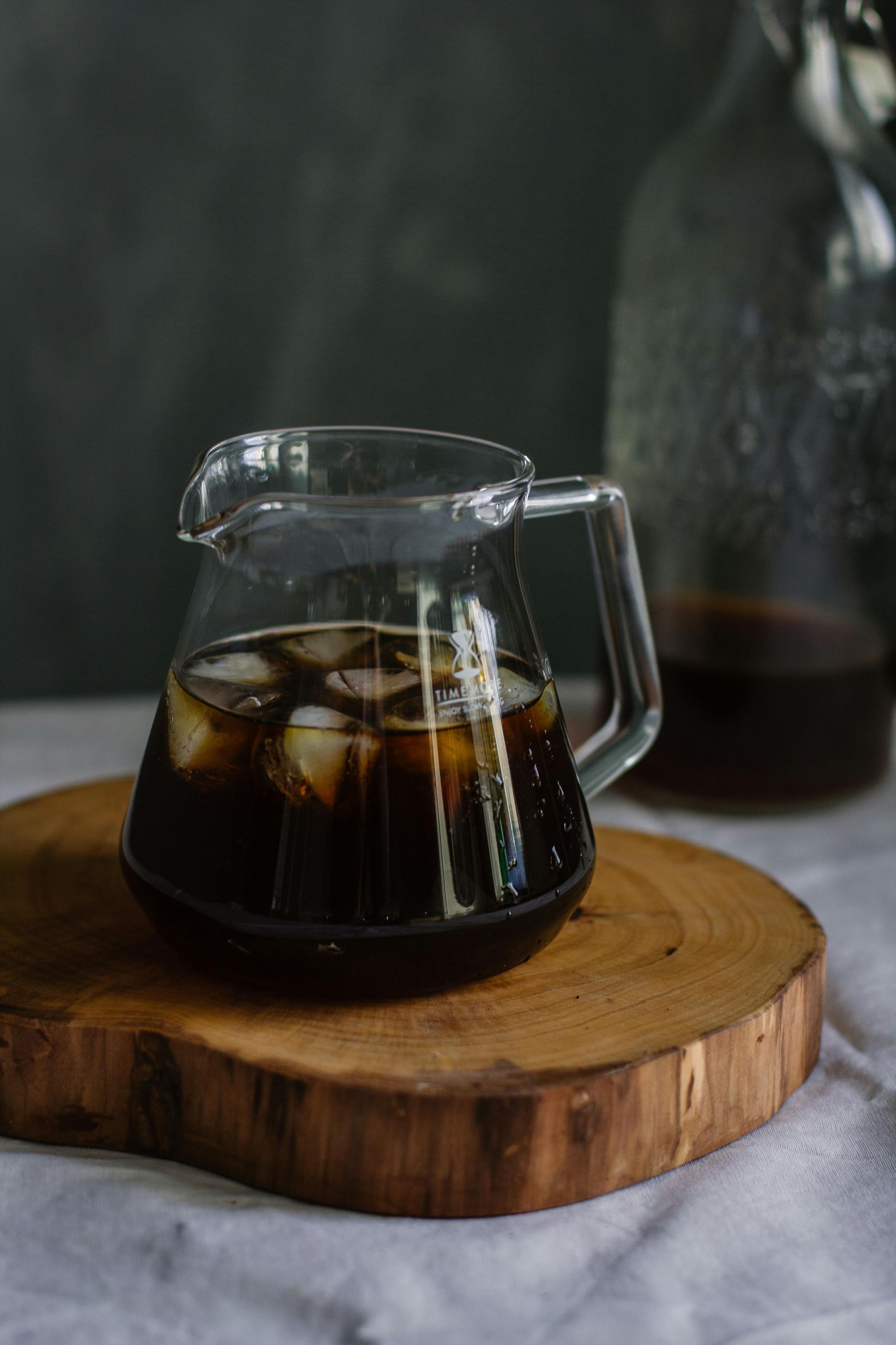 A pitcher of Cold Brew coffee is sitting on a wooden cutting board at the coffee culture in Fort Lauderdale.
