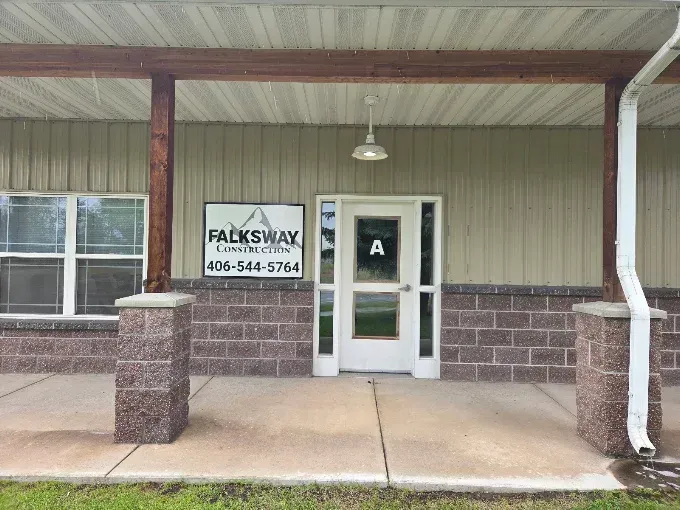 Front porch entrance to a building with a sign for FAXSWAY on the wall.