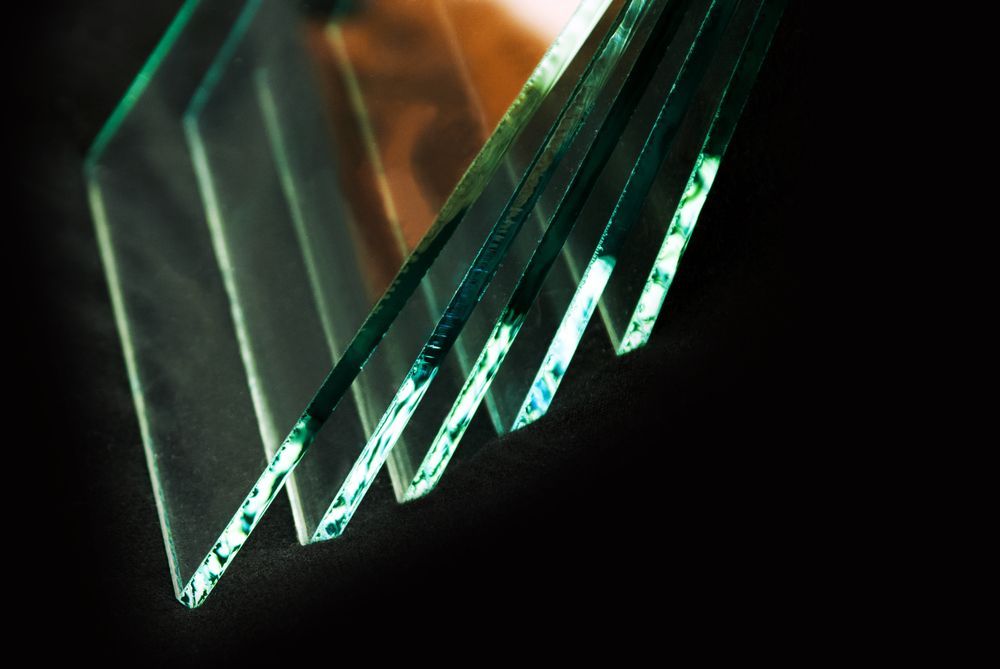 Stacked Glass Sheets with Beveled Edges, Teal and White, on A Black Background — Isa Auto Glass & Upholstery In Burketown, QLD