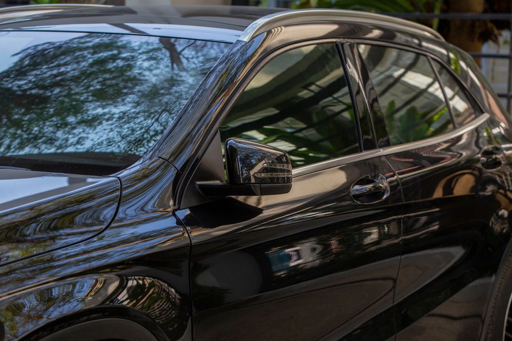 Black Car, Side View, in Natural Light. Reflective Surface Shows Surroundings — Isa Auto Glass & Upholstery In Bedourie, QLD