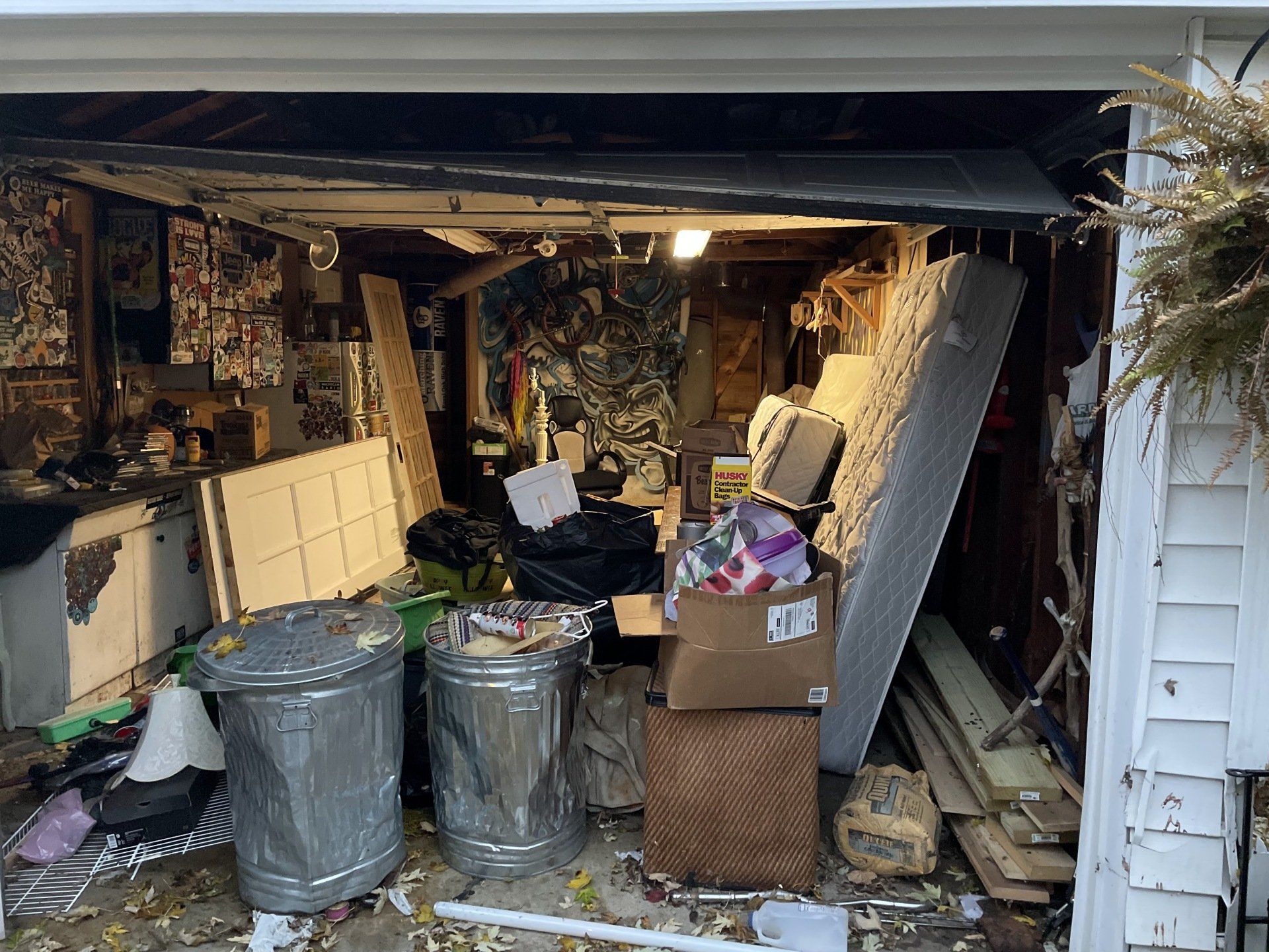 Garage cleanout with old mattresses, furniture, and unwanted items ready for junk removal in Aurora,