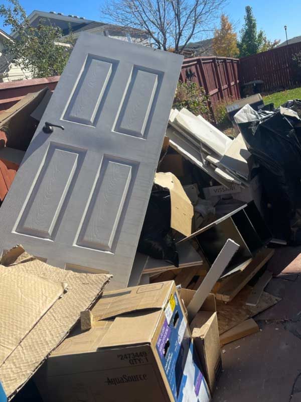 a door is sitting on top of a pile of cardboard boxes .