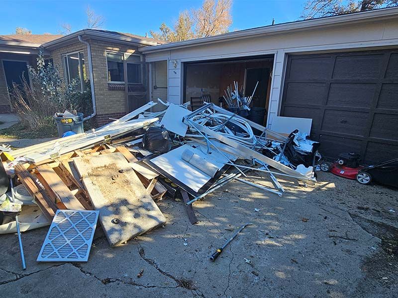 a pile of trash is sitting in front of a garage door