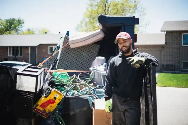 Worker hauling junk items