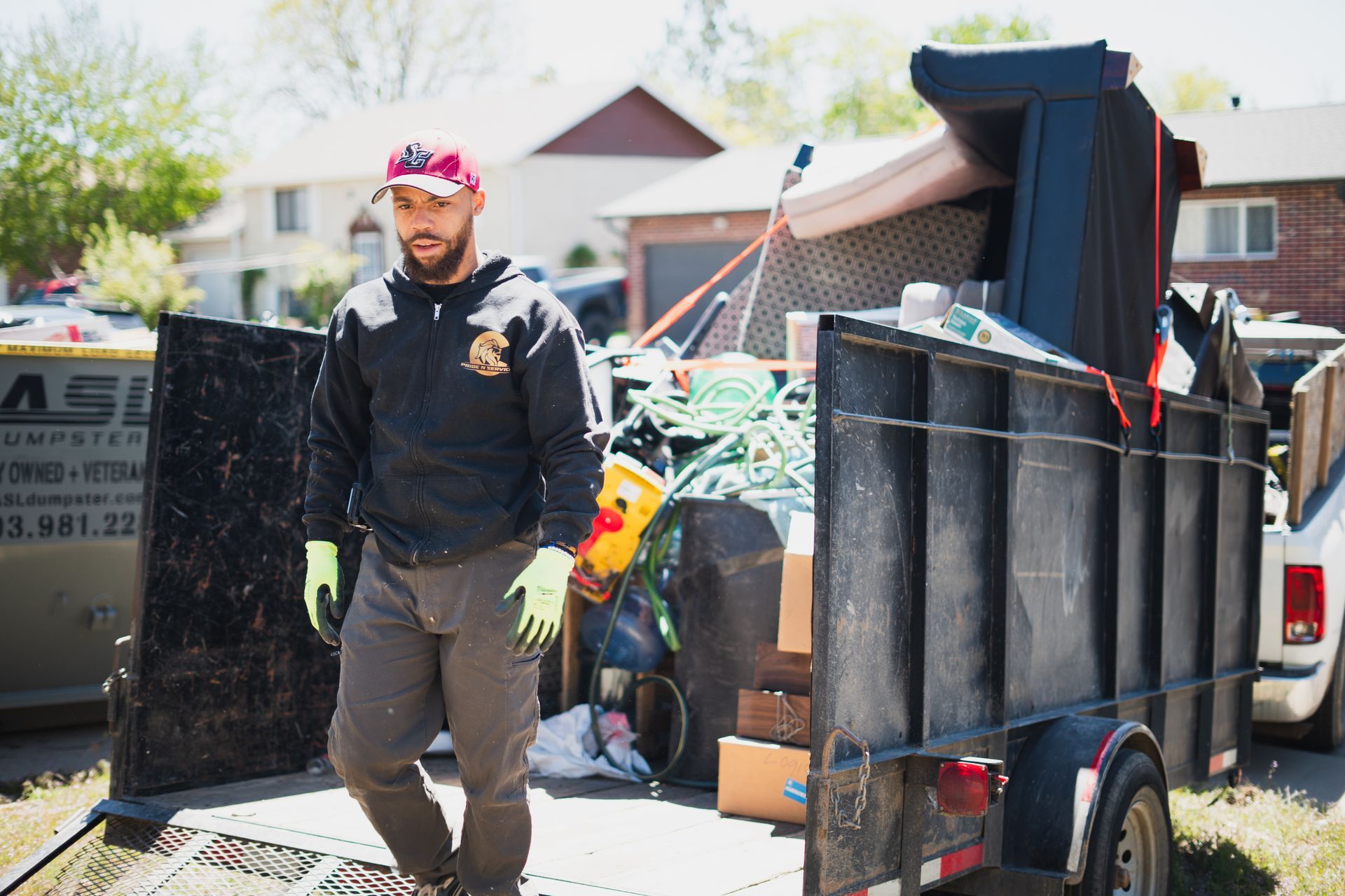Worker loading recyclables trailer